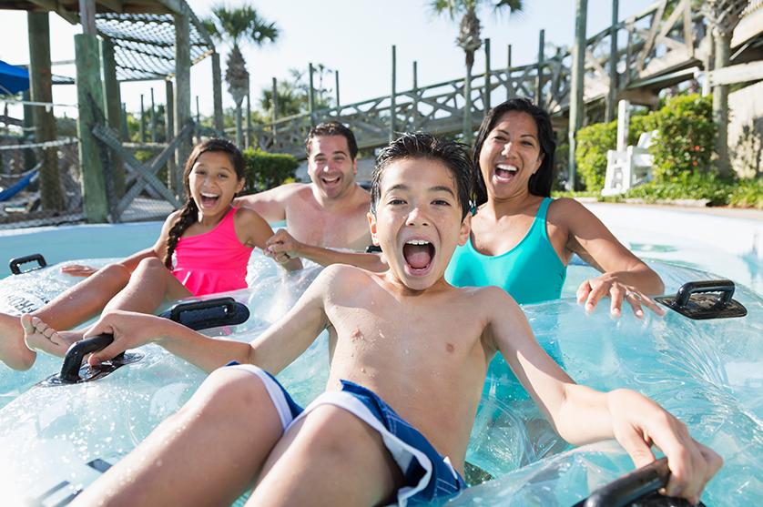 A family having fun on vacation on a waterslide