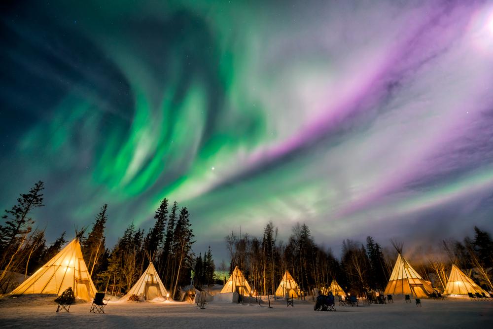 Sit under the Aurora Borealis while tipi camping on a Yellowknife tour